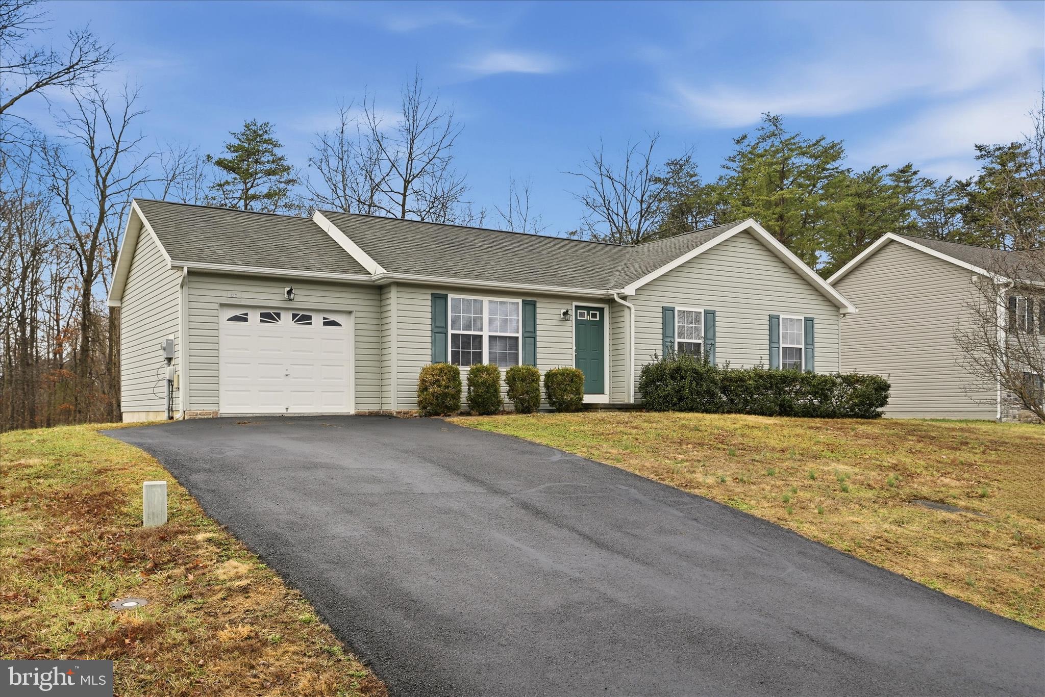 104 Basin Drive Inwood, WV 25428 - Photo 22 of 26 a front view of a house with a yard and garage