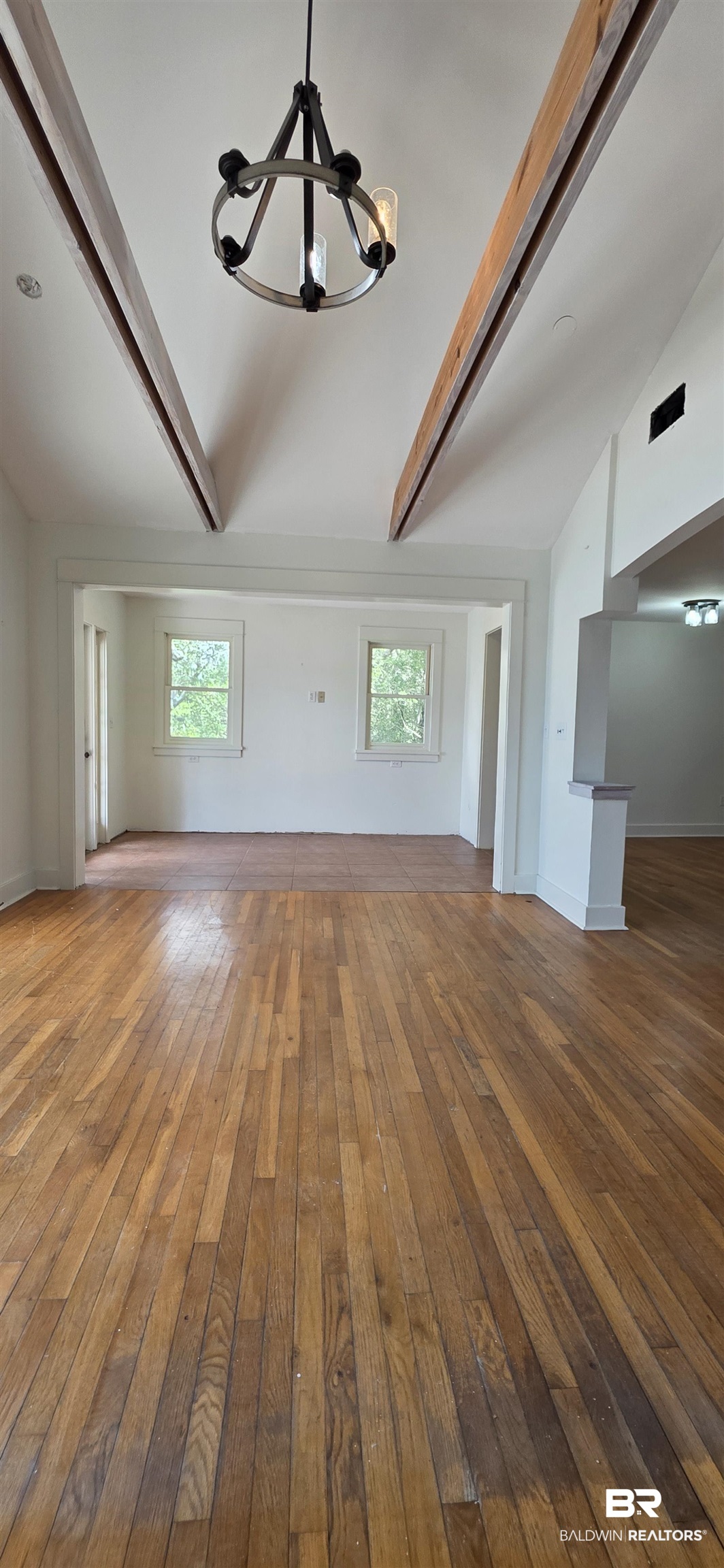 544 Windmill Ridge Road Gulf Shores, AL 36542 - Photo 12 of 50 Unfurnished living room featuring a chandelier, hardwood / wood-style floors, and plenty of natural light