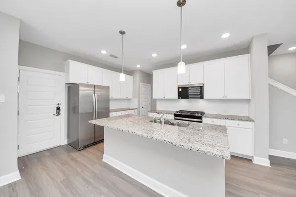 a view of a kitchen and wooden floor