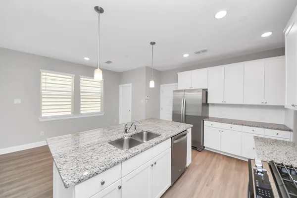a kitchen with a sink stove and refrigerator