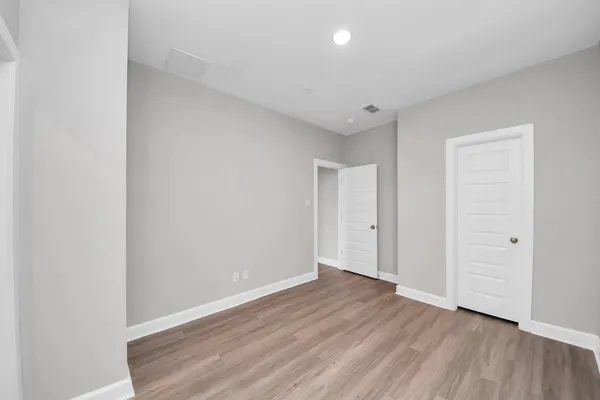 a bathroom with a granite countertop bathtub shower sink vanity mirror and toilet