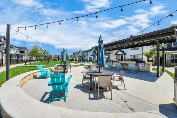 a view of a roof deck with table and chairs