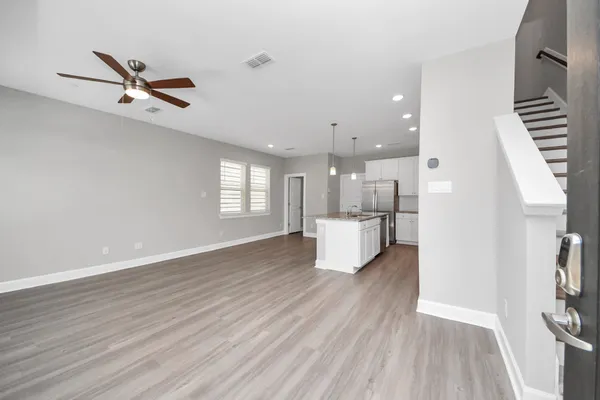 a living room with furniture and wooden floor
