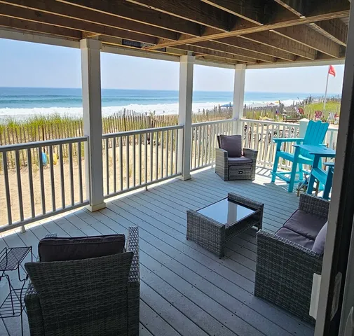 a living room with furniture and floor to ceiling windows