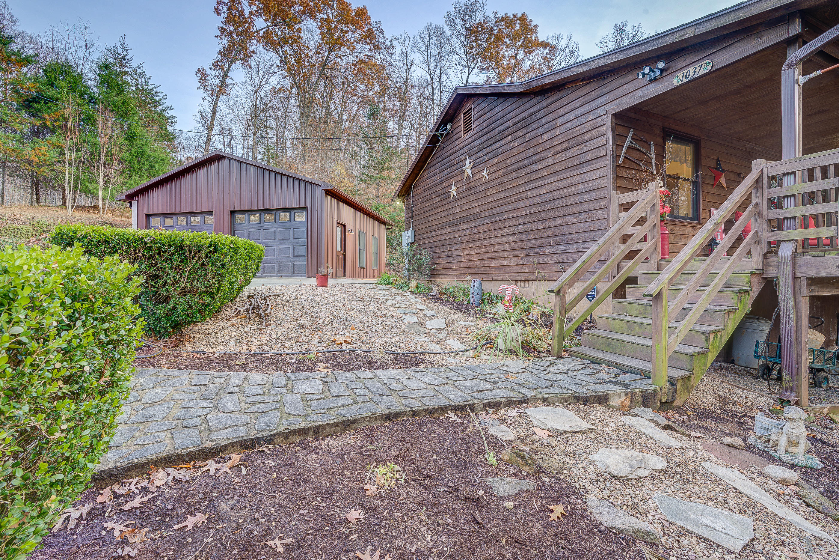 1037 Buck Mountain Road Goodview, VA 24095 - Photo 2 of 31 a backyard of a house with a garden and entertaining space