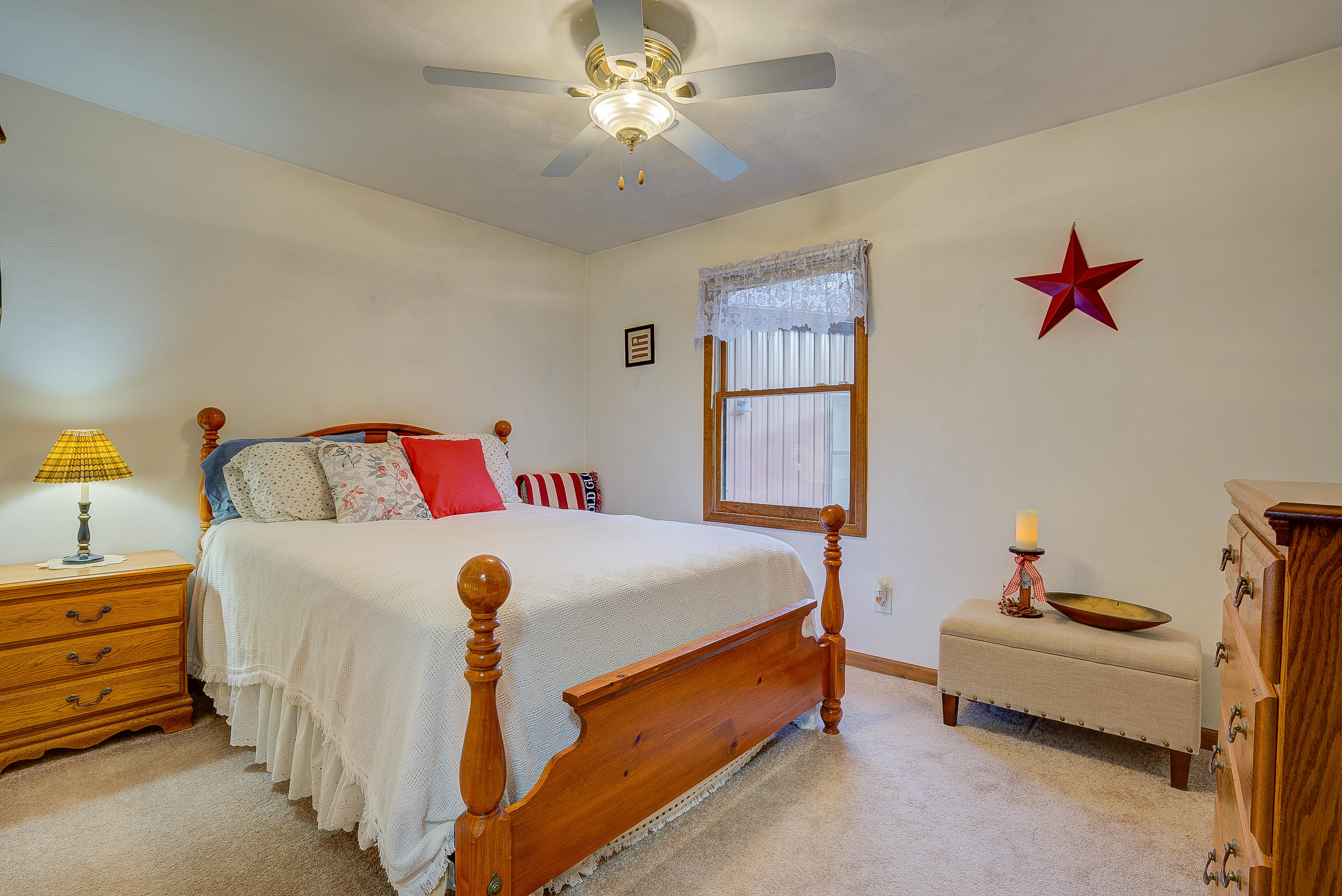 1037 Buck Mountain Road Goodview, VA 24095 - Photo 19 of 31 a bedroom with a bed and a chandelier