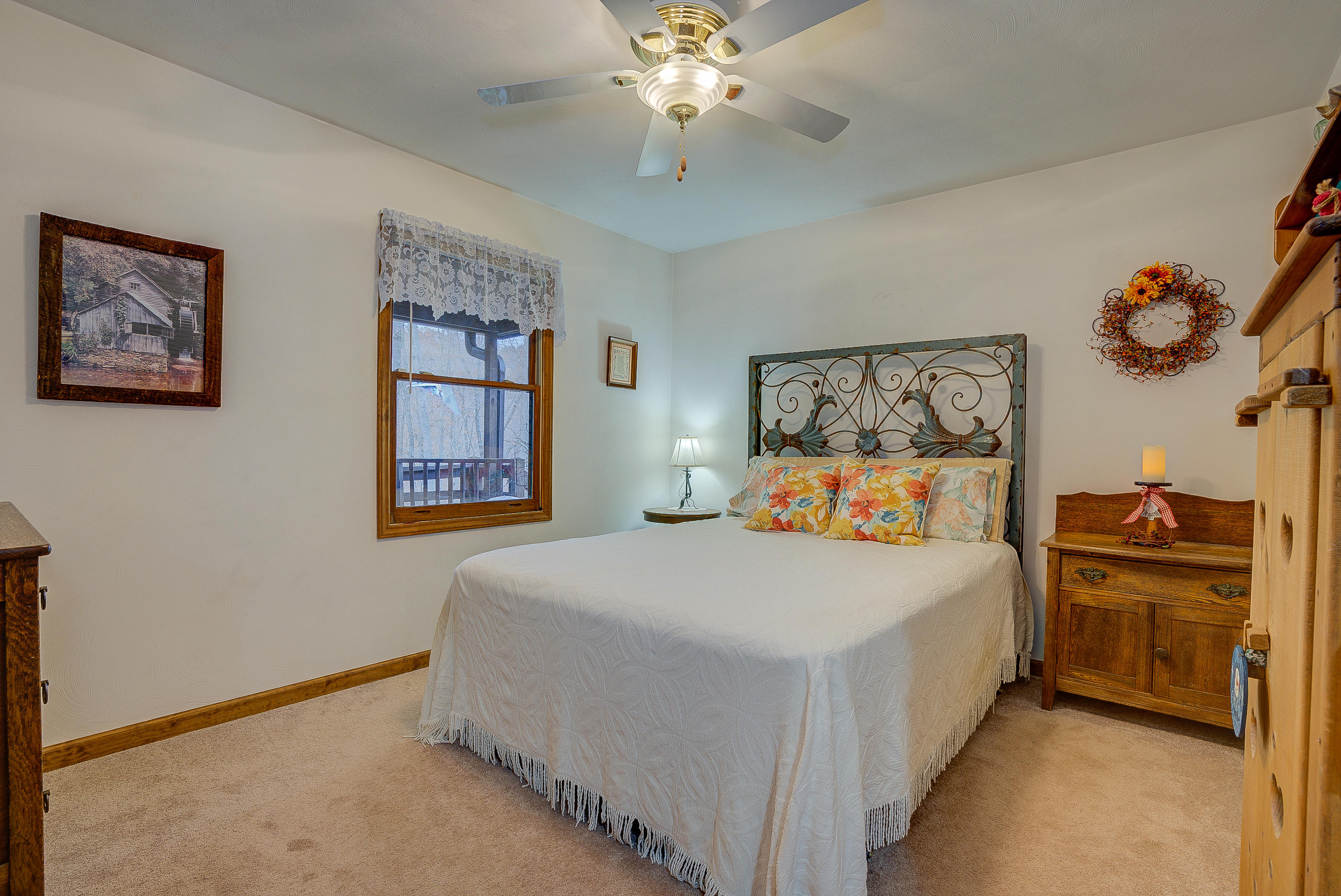 1037 Buck Mountain Road Goodview, VA 24095 - Photo 20 of 31 a bedroom with a bed and a chandelier