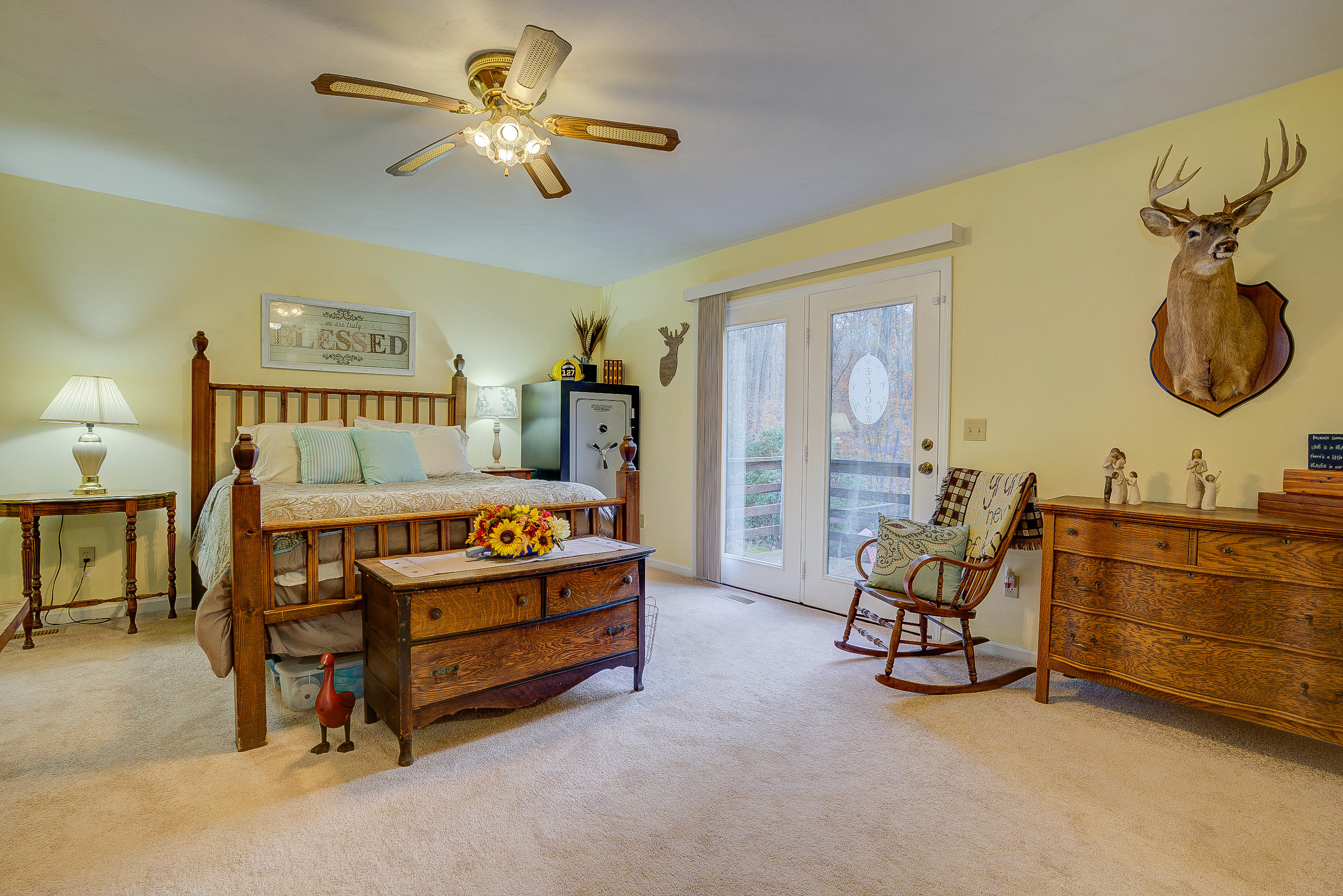1037 Buck Mountain Road Goodview, VA 24095 - Photo 22 of 31 a bedroom with furniture and a chandelier fan
