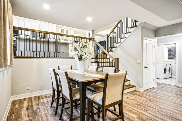 a view of a dining room with furniture and wooden floor