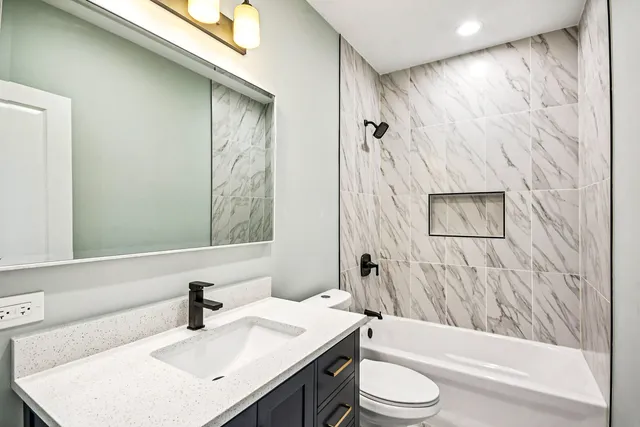 a bathroom with a sink toilet and shower