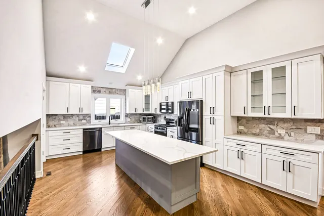 a large kitchen with cabinets and stainless steel appliances
