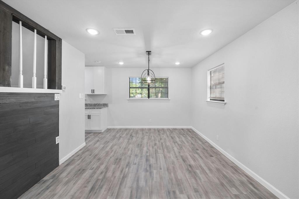 1312 East Collin Street Corsicana, TX 75110 - Photo 11 of 24 wooden floor in an empty room with a window