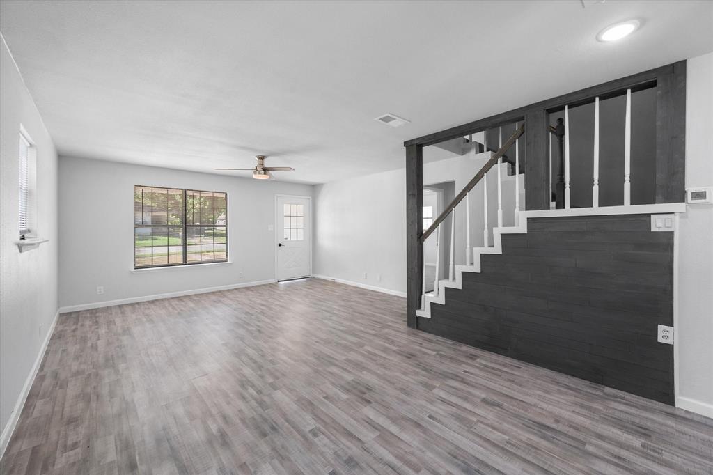 1312 East Collin Street Corsicana, TX 75110 - Photo 13 of 24 a view of an empty room with wooden floor and a window