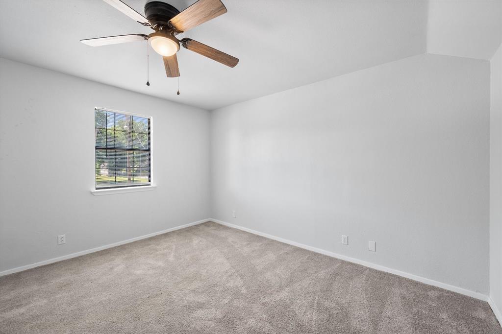 1312 East Collin Street Corsicana, TX 75110 - Photo 19 of 24 an empty room with a window and a fan