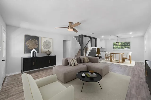 a living room with furniture and a wooden floor