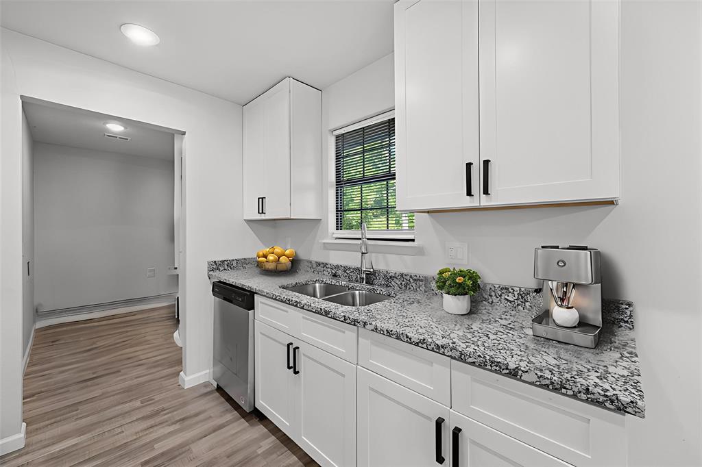 1312 East Collin Street Corsicana, TX 75110 - Photo 3 of 24 a kitchen with sink a window and cabinets