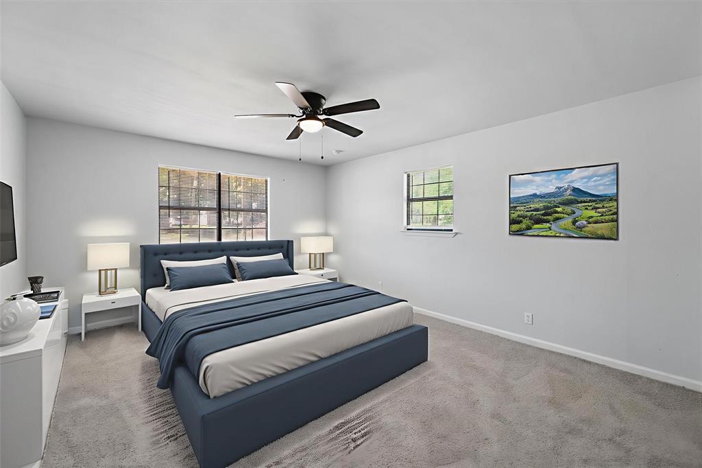 1312 East Collin Street Corsicana, TX 75110 - Photo 4 of 24 a bedroom with a large bed and a chandelier