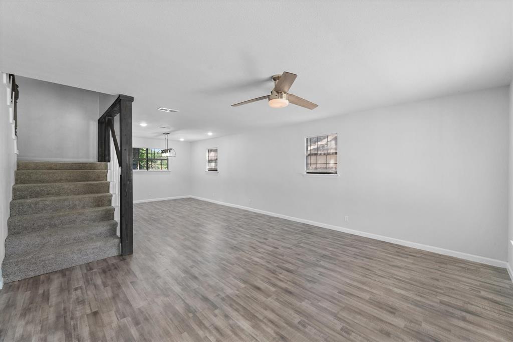 1312 East Collin Street Corsicana, TX 75110 - Photo 7 of 24 a view of an empty room with wooden floor and a window