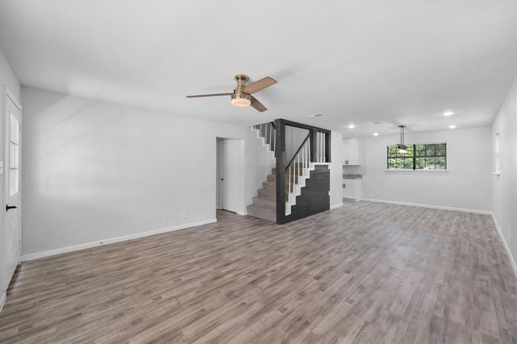 1312 East Collin Street Corsicana, TX 75110 - Photo 8 of 24 a view of empty room with wooden floor and ceiling fan