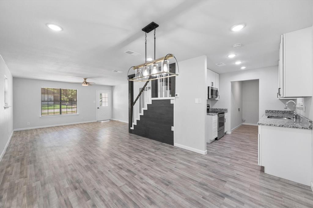 1312 East Collin Street Corsicana, TX 75110 - Photo 10 of 24 a view of a kitchen with refrigerator and wooden floor