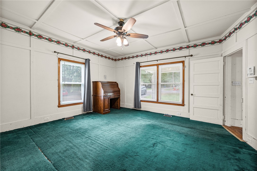 47 Square Street Pelzer, SC 29669 - Photo 21 of 29 Richly patterned wood-trimmed ceilings accent this versatile living space with classic wall paneling.