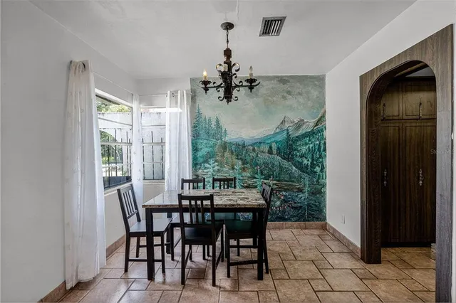 a dining room with furniture and window