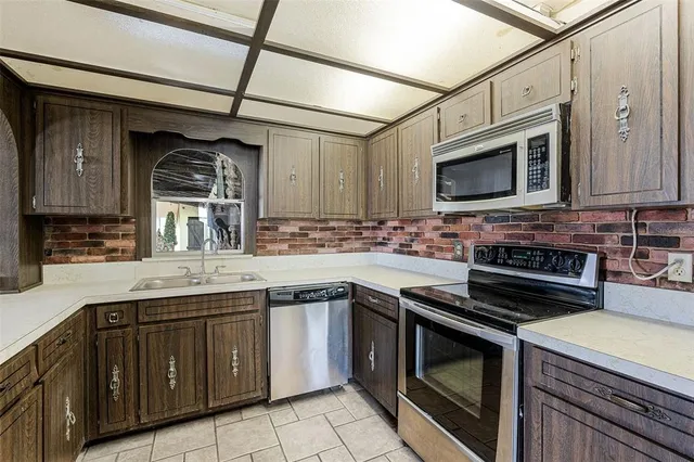 a kitchen with stainless steel appliances granite countertop a stove and a microwave