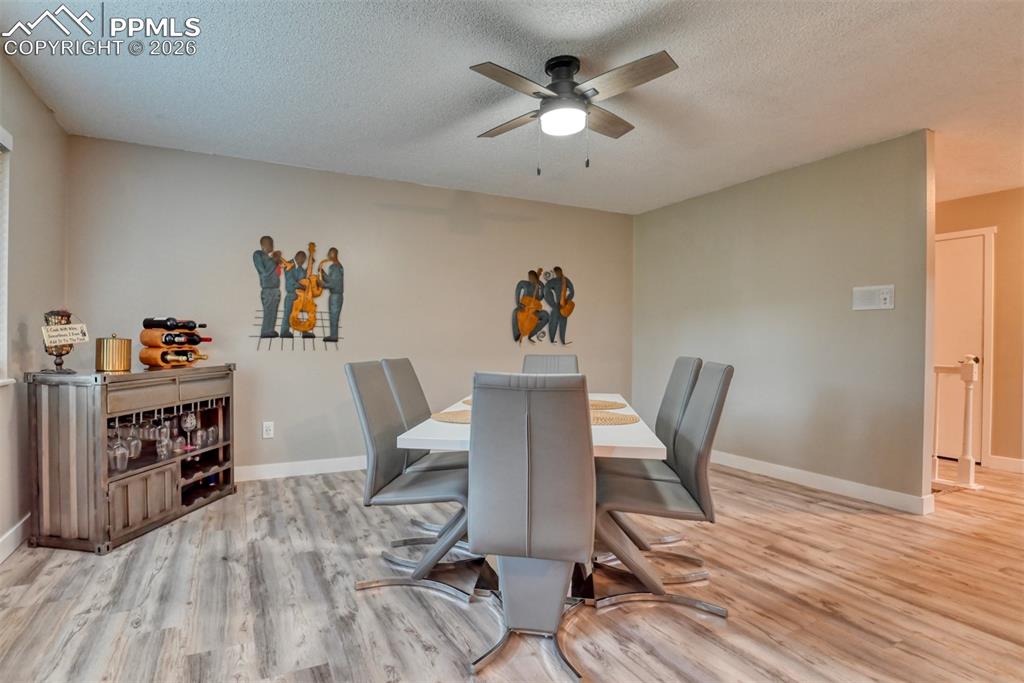 4506 Ridgecrest Drive Colorado Springs, CO 80918 - Photo 11 of 49 a view of a workspace with furniture and wooden floor