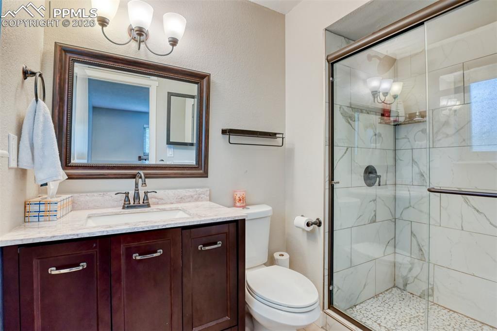 4506 Ridgecrest Drive Colorado Springs, CO 80918 - Photo 20 of 49 a bathroom with a sink a toilet and shower