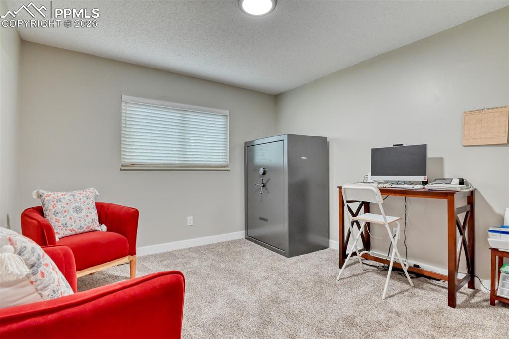 4506 Ridgecrest Drive Colorado Springs, CO 80918 - Photo 22 of 49 a living room with furniture a flat screen tv and a window