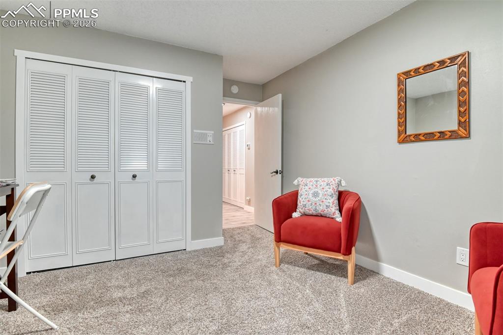 4506 Ridgecrest Drive Colorado Springs, CO 80918 - Photo 23 of 49 a bedroom with furniture and a chair
