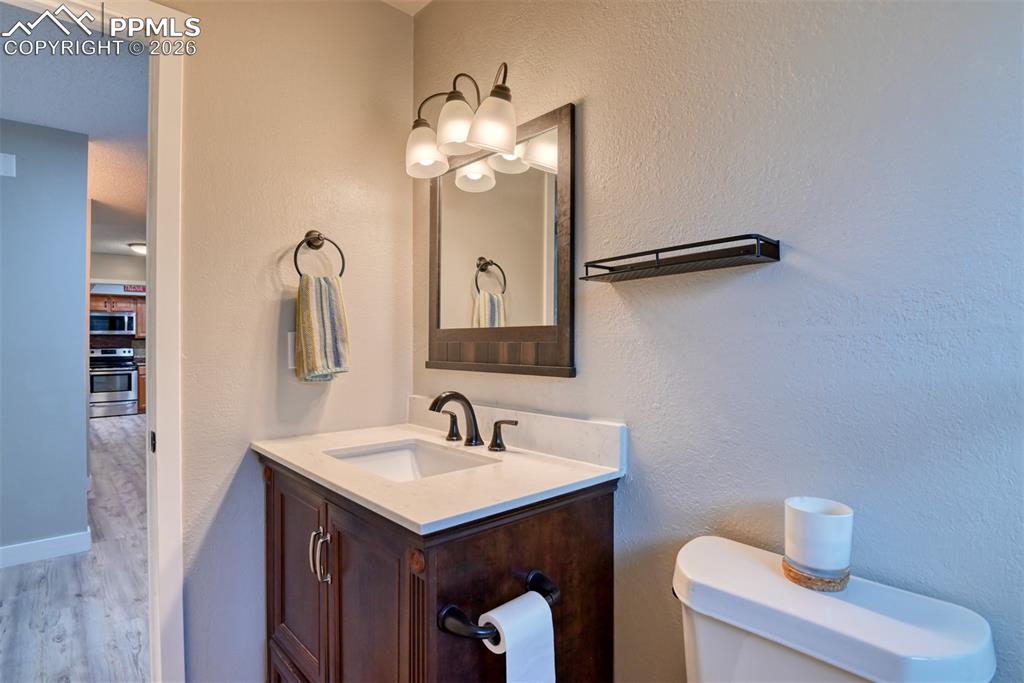 4506 Ridgecrest Drive Colorado Springs, CO 80918 - Photo 24 of 49 a bathroom with a toilet sink and mirror