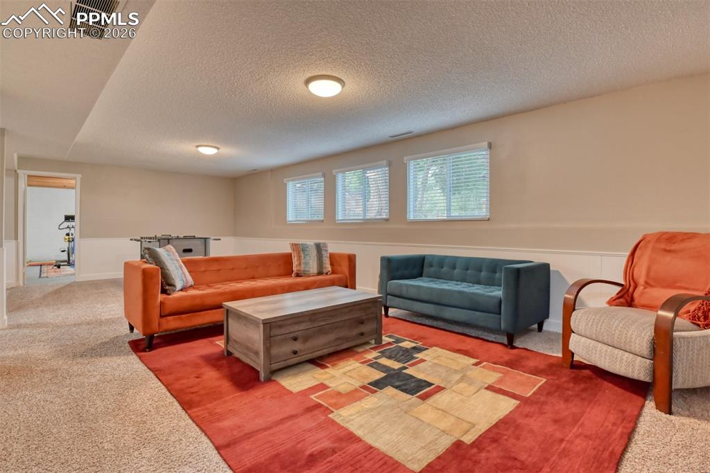 4506 Ridgecrest Drive Colorado Springs, CO 80918 - Photo 28 of 49 a living room with furniture and a rug