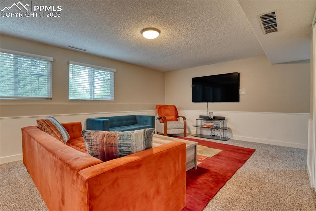 4506 Ridgecrest Drive Colorado Springs, CO 80918 - Photo 30 of 49 a living room with furniture and a flat screen tv