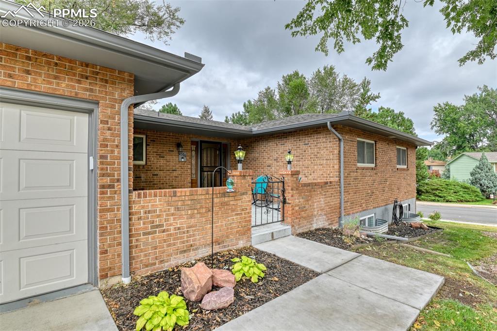 4506 Ridgecrest Drive Colorado Springs, CO 80918 - Photo 3 of 49 a front view of a house with a yard