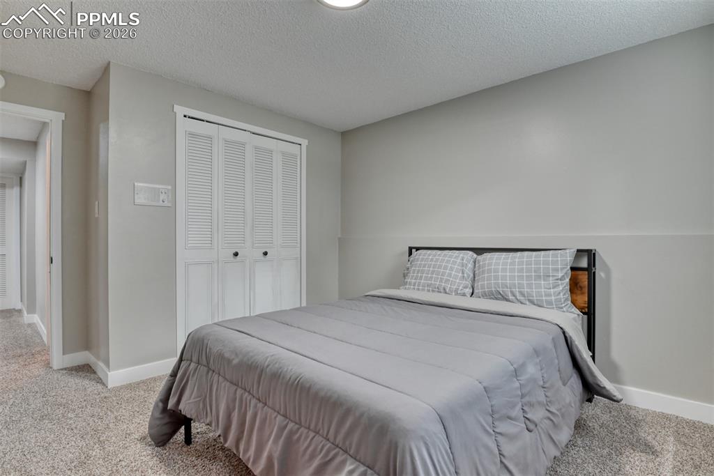 4506 Ridgecrest Drive Colorado Springs, CO 80918 - Photo 38 of 49 a bedroom with a bed and closet