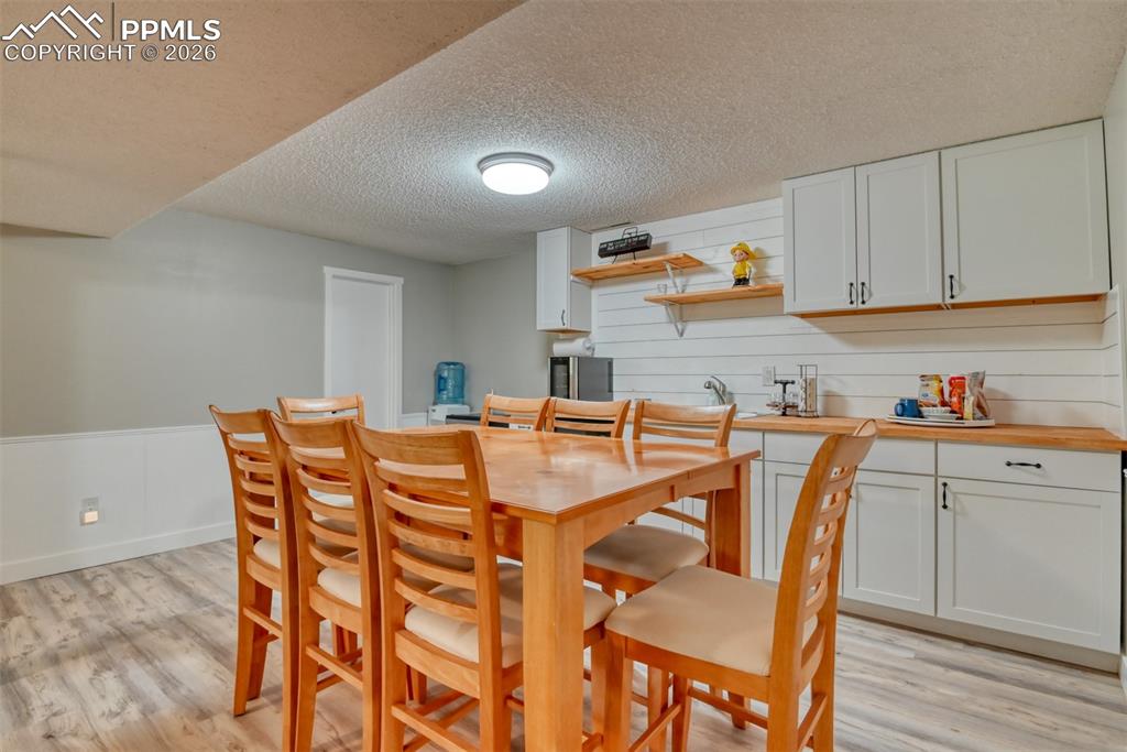 4506 Ridgecrest Drive Colorado Springs, CO 80918 - Photo 41 of 49 a dining room with furniture and wooden floor