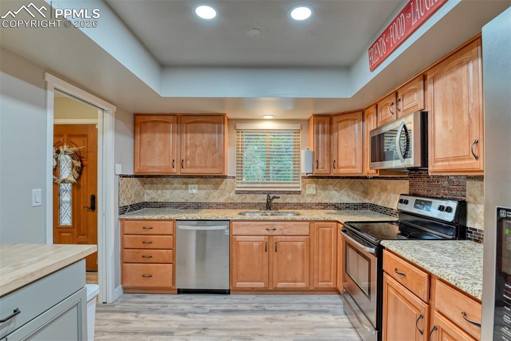 4506 Ridgecrest Drive Colorado Springs, CO 80918 - Photo 6 of 49 a kitchen with a sink stove and cabinets