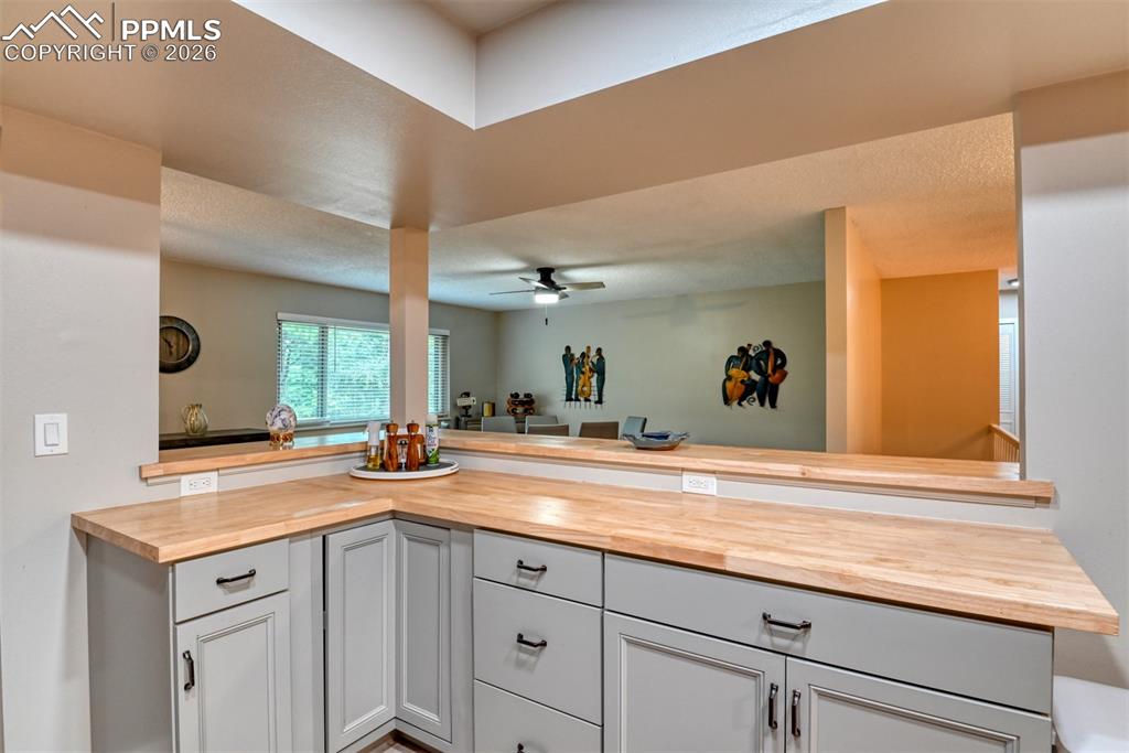 4506 Ridgecrest Drive Colorado Springs, CO 80918 - Photo 8 of 49 a view of a sink a mirror and wooden cabinets