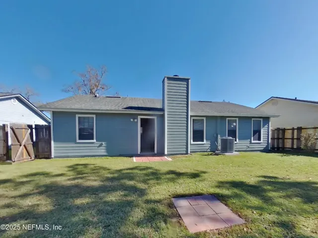 a house view with a sitting space and garden