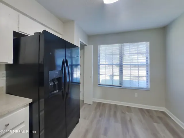 a kitchen with a refrigerator and window