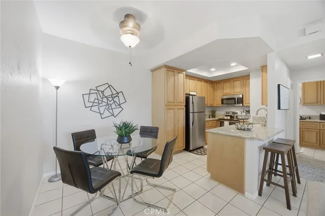 an aerial view of a residential apartment building with a yard and seating area