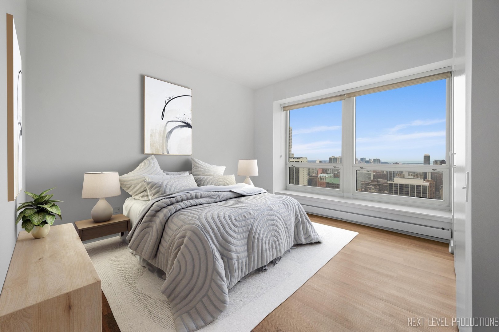 57 East Delaware Place, Unit 3203 Chicago, IL 60611 - Photo 11 of 27 a bedroom with a large bed and a large window