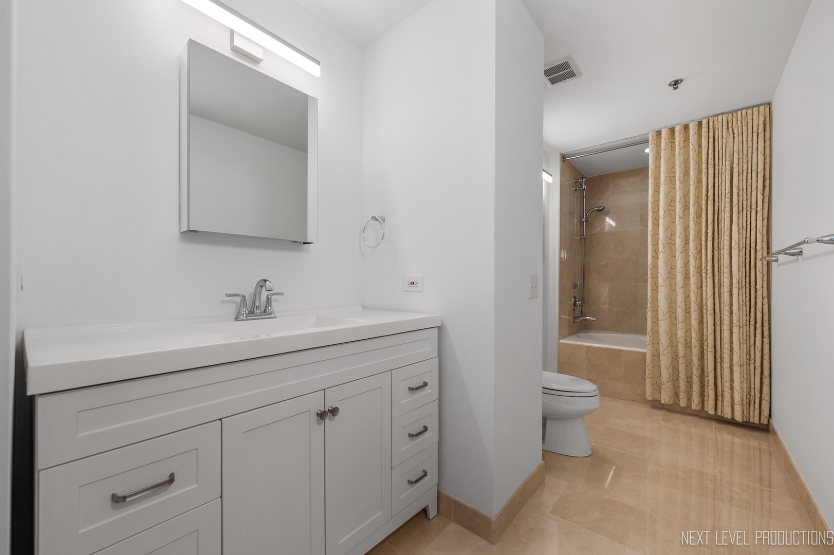 57 East Delaware Place, Unit 3203 Chicago, IL 60611 - Photo 15 of 27 a bathroom with a toilet a sink a mirror and a shower