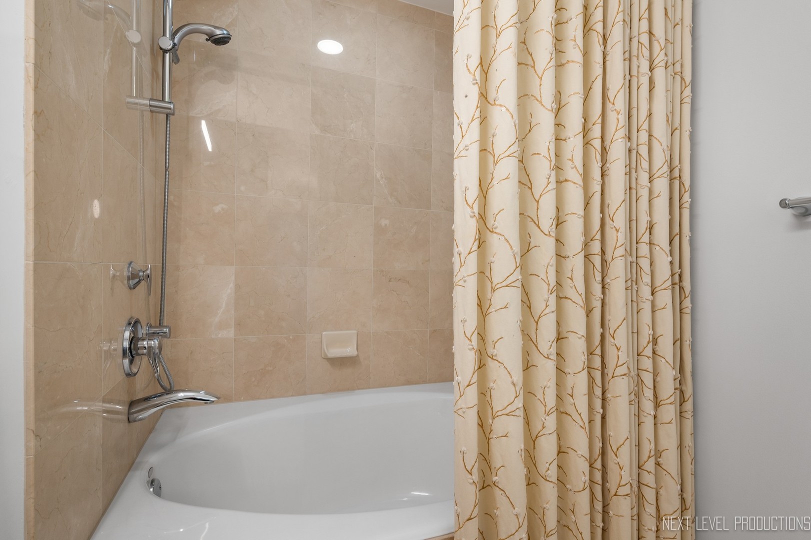 57 East Delaware Place, Unit 3203 Chicago, IL 60611 - Photo 16 of 27 a bathroom with a shower and a tub