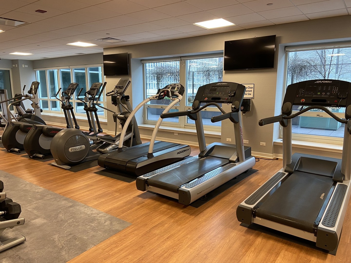 57 East Delaware Place, Unit 3203 Chicago, IL 60611 - Photo 18 of 27 a room with gym equipment and a flat screen tv