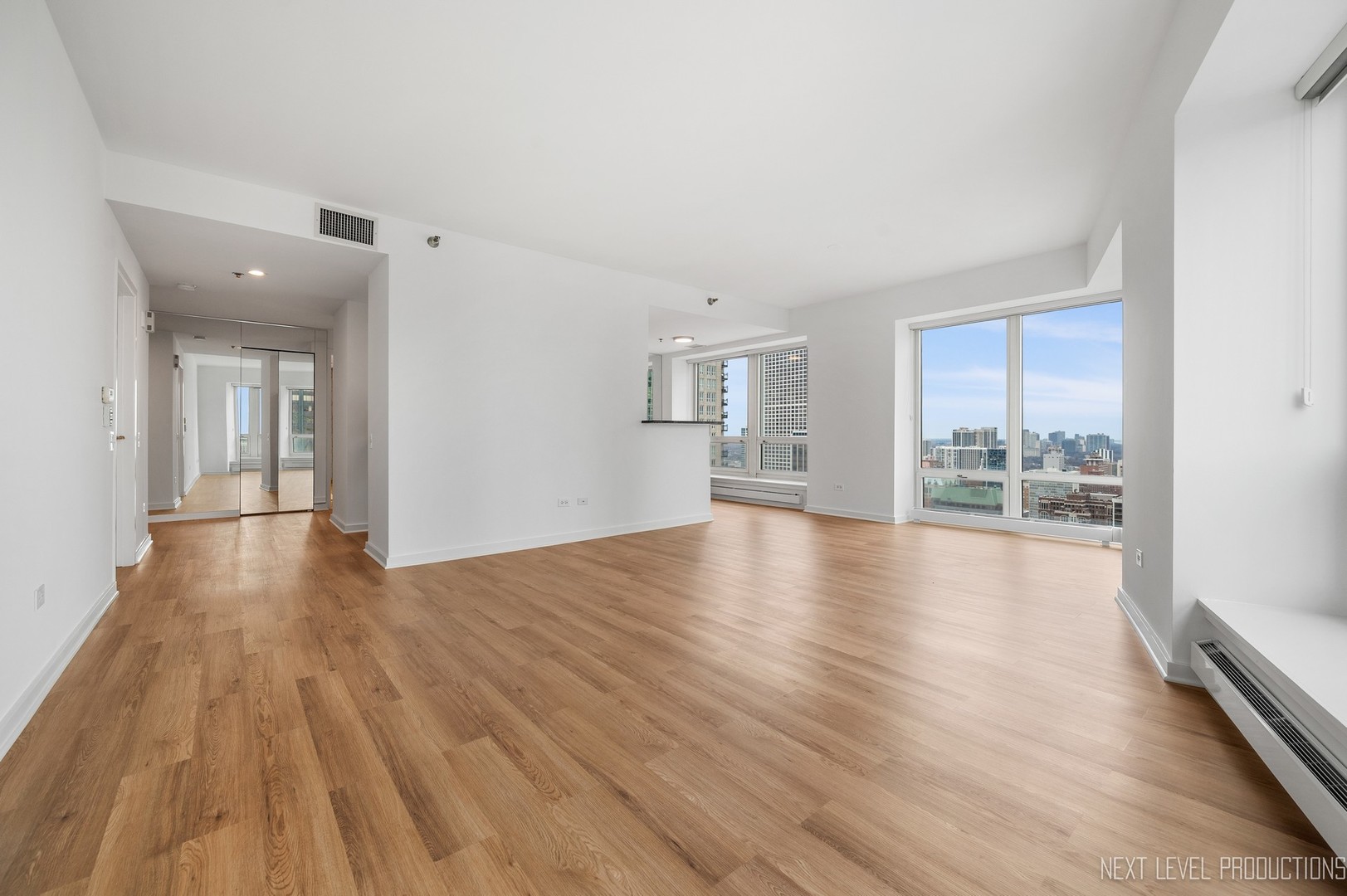 57 East Delaware Place, Unit 3203 Chicago, IL 60611 - Photo 7 of 27 wooden floor in an empty room with a window