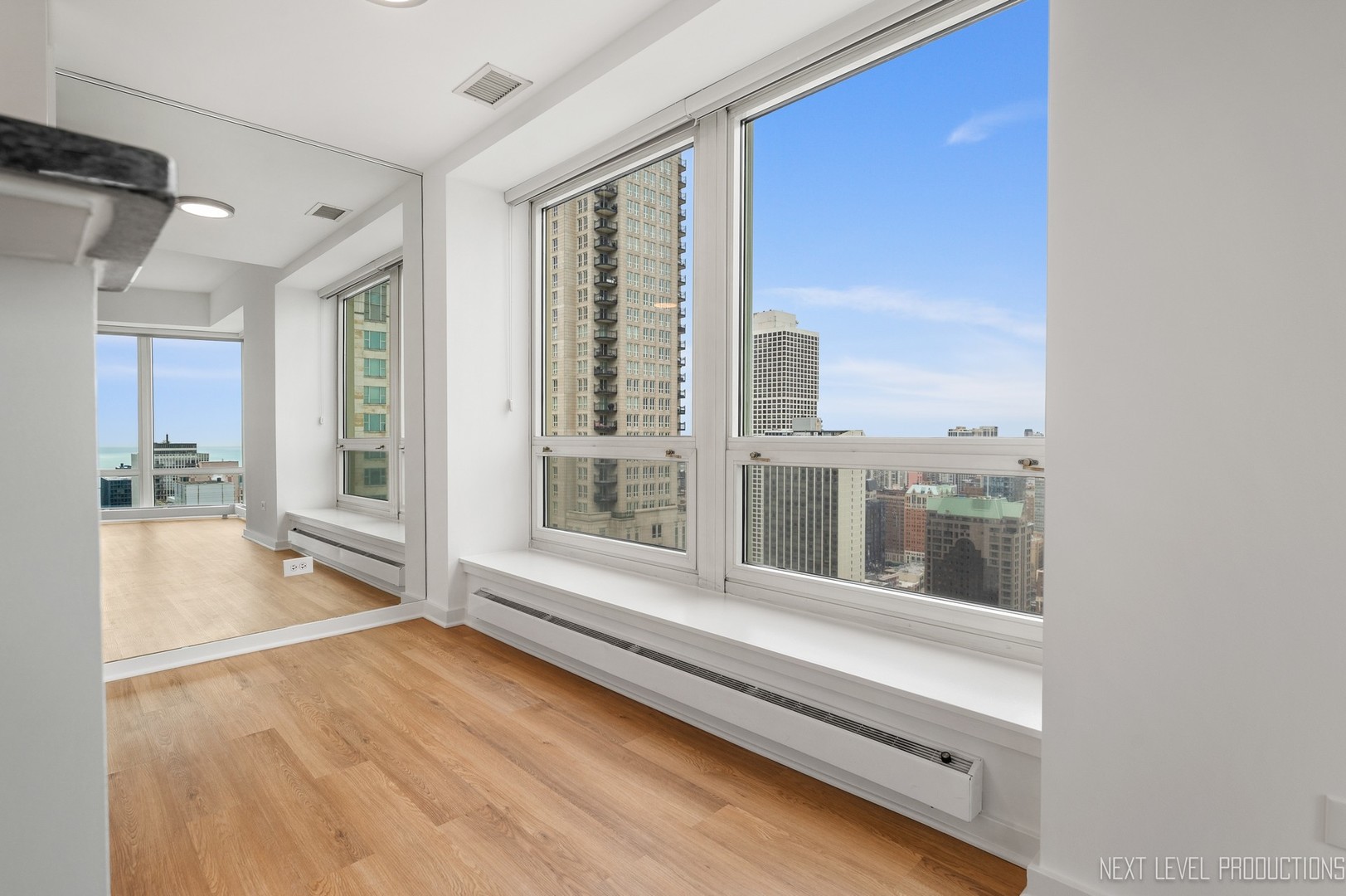 57 East Delaware Place, Unit 3203 Chicago, IL 60611 - Photo 10 of 27 a view of a living room with a large window
