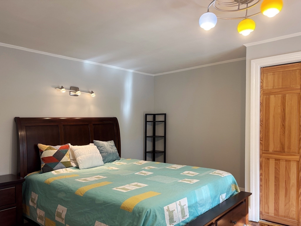 50 Dwhinda Road Newton, MA 02468 - Photo 29 of 42 a bedroom with a bed and lamps