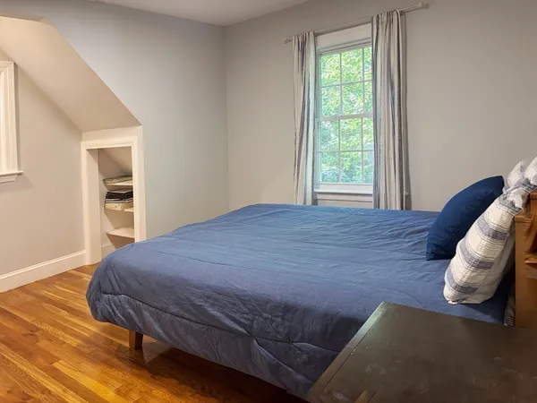 a bedroom with a bed and a window